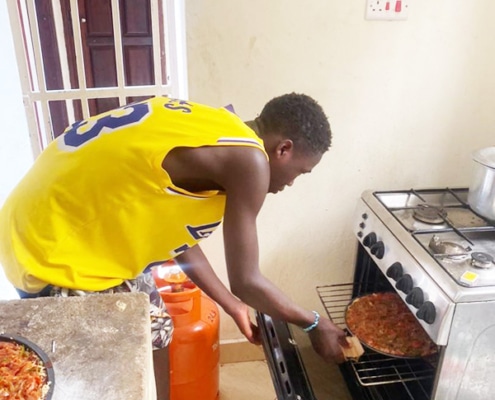 A former street boy from Kampala making pizza