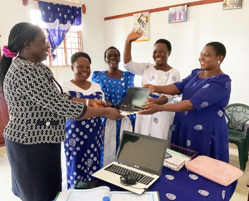Delivering donated laptops to the Mothers' Union in Uganda