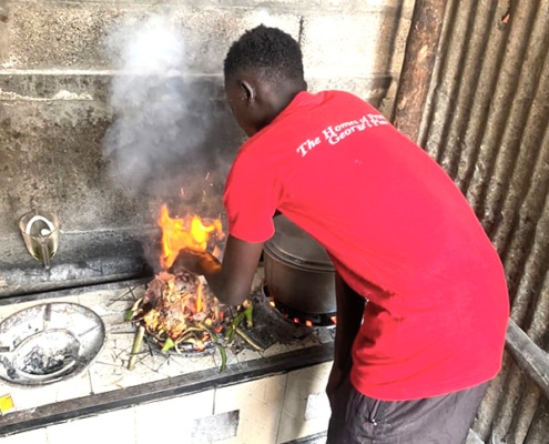 Former homeless boy cooking at the charity