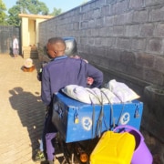 A former homeless boy going to school by boda