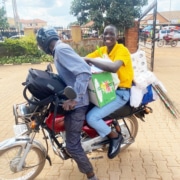 One of the boys on the back of a boda boda